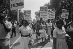 FILE PHOTO: A procession carrying signs for equal rights, integrated schools, decent housing, and an end to bias during th...