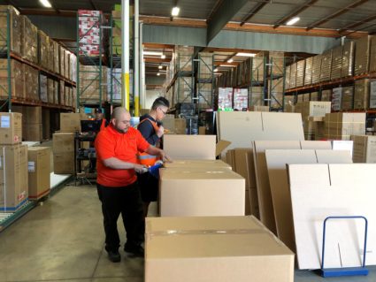 A worker tapes up a box at NewAir's warehouse in Cypress