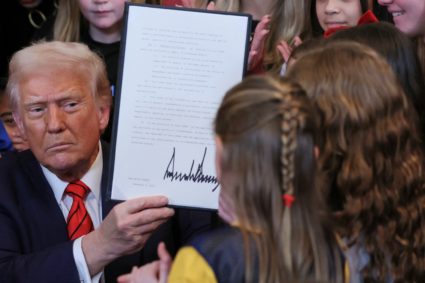 U.S. President Donald Trump signs an executive order banning transgender girls and women from participating in women's spo...