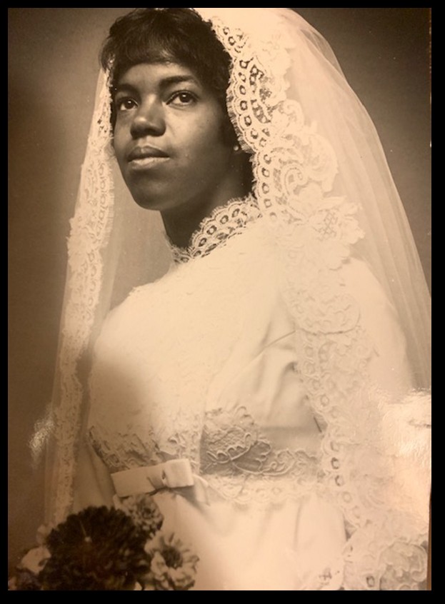 sepia toned bridal portrait with bride holding flowers from her father's garden, Ann Arbor, Michigan, 1971