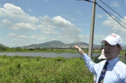 USAID Mission Director for Vietnam Donovan talks to media in front of Lotus Lake during joint US-Vietnam Dioxin Cleaning P...