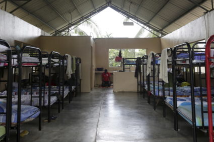 Migrant from Ghana prays inside a provisional migrant shelter in Meteti in the Darien Province