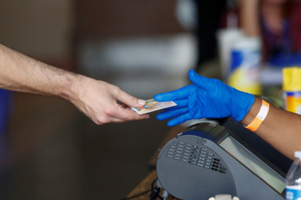 A voter hands out his ID to a poll worker before casting his ballot during the Democratic presidential primary election at...