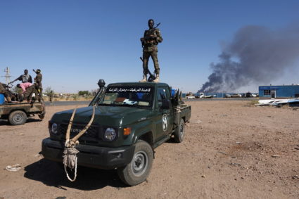 Sudan's army soldiers celebrate the army's liberation of an oil refinery, in North Bahri, Sudan