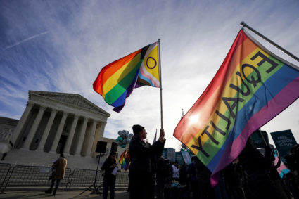FILE PHOTO: Activists gather outside U.S. Supreme Court as justices hear arguments in case involving LGBT rights in Washin...