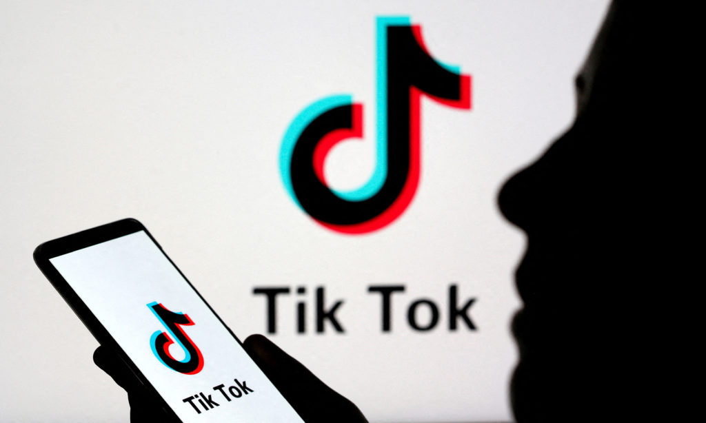 FILE PHOTO: FILE PHOTO: Person holds a smartphone with Tik Tok logo displayed in this picture illustration