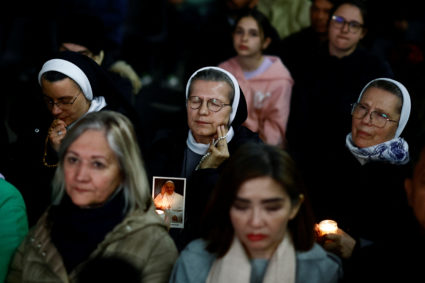 Faithful attend a prayer service at the Vatican