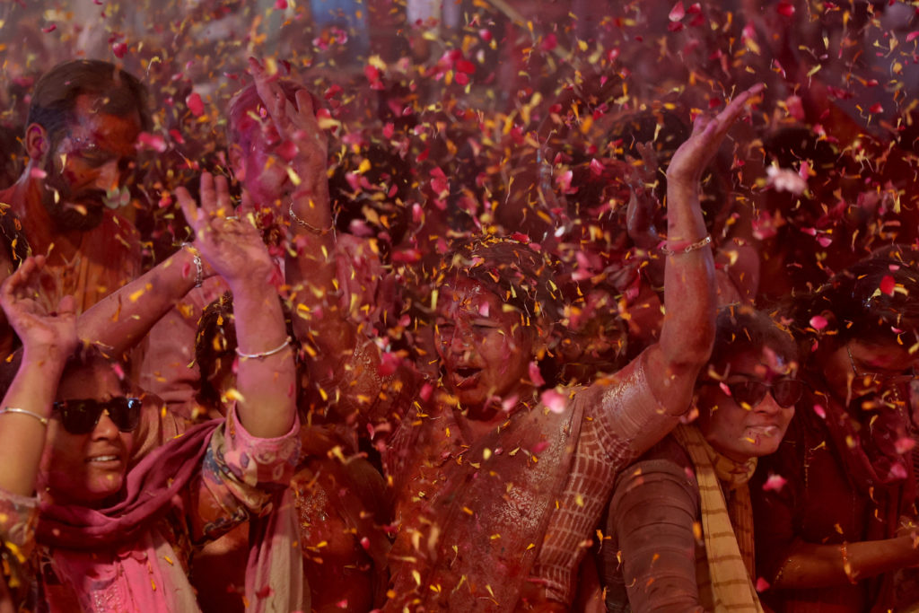 Hindu devotees dance during Holi celebrations inside a temple in Ahmedabad,