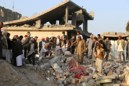 People gather on the rubble of a house hit by a U.S. strike in Saada