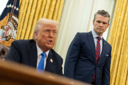 U.S. Defense Secretary Pete Hegseth speaks next to President Donald Trump, in the Oval Office at the White House, in Washi...