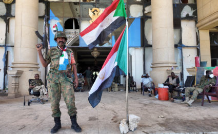 Sudanese army members stand at the presidential palace, after the Sudanese army said it had taken control of the building,...