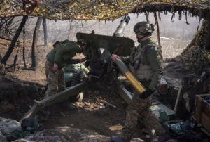 Servicemen of the Ukrainian National Guard lfire a howitzer towards Russian troops at a position in a front line near the ...