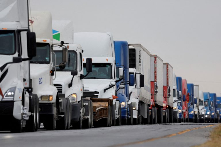 FILE PHOTO: Trucks wait in line to cross into the United States, at the World Trade Bridge