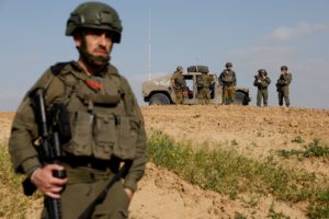 Soldiers stand guard by the Israel-Gaza border