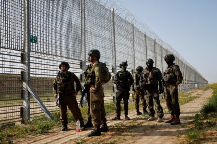 Soldiers keep guard by the Israel-Gaza border fence