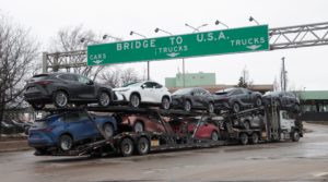 A car hauler drives towards the Ambassador Bridge to Detroit, Michigan from Windsor
