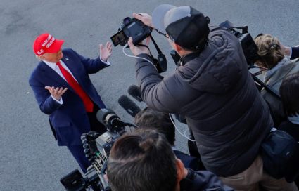 U.S. President Donald Trump speaks with members of the media on the South Lawn before boarding Marine One at the White House