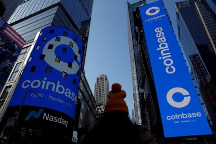 FILE PHOTO: The logo for Coinbase Global Inc is displayed on the Nasdaq MarketSite jumbotron and others at Times Square in...