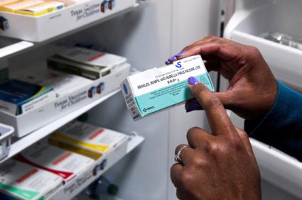 FILE PHOTO: A doctor points to MMR vaccines in Lubbock, Texas