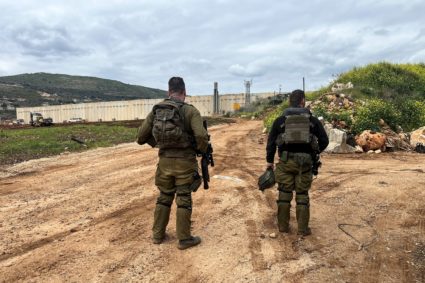 Israeli soldiers stand at the Israeli side of the Israel Lebanon border