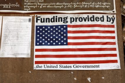 A poster is displayed inside a food distribution building at the Umpiem Mai Refugee Camp following a halt in U.S. foreign aid