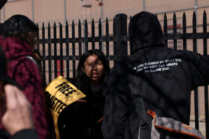 People protest outside the Immigration and Customs Enforcement facility in Aurora