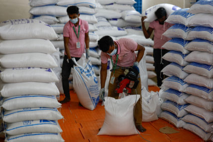 Workers pack rice at the World Food Programme distribution center, at the refugee camp in Cox's Bazar