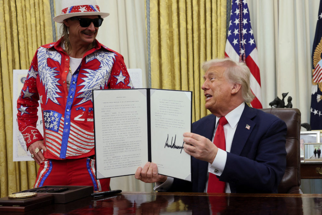 U.S. President Donald Trump signs an executive order in the Oval Office, in Washington
