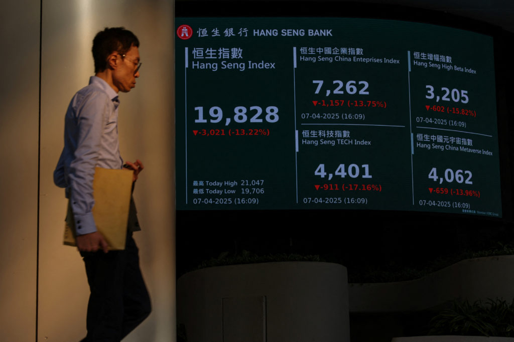 A screen displays the closing Hang Seng Index at Central district, in Hong Kong