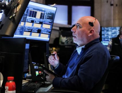 Trader works during the closing bell, on the floor at the New York Stock Exchange (NYSE) in New York City