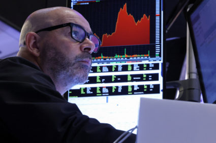 Traders work on the floor at the New York Stock Exchange, in New York City