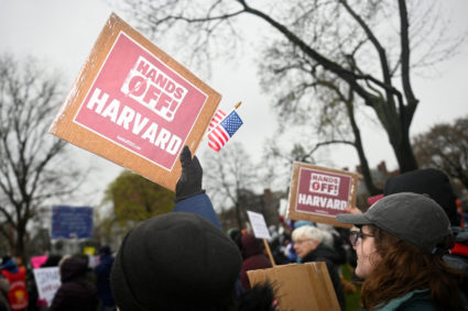 Demonstrators rally on Cambridge Common in a protest organized by the City of Cambridge against interference by the federa...