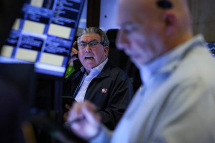 Traders work on the floor of the NYSE in New York