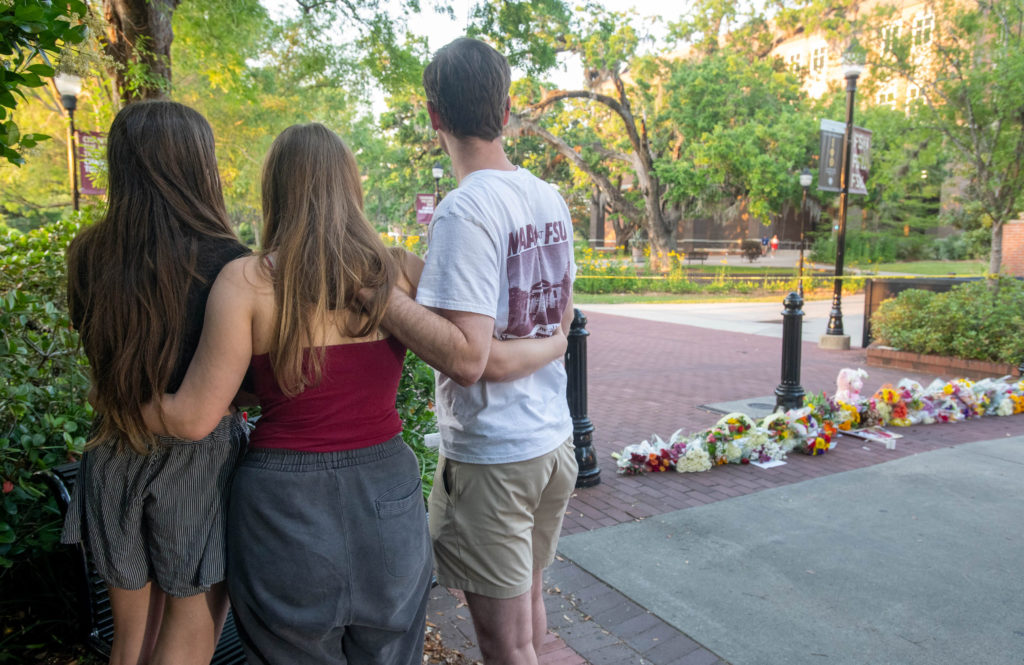 People mourn at a makeshift memorial near the scene of a shooting on the Florida State University (FSU) campus in Tallahassee