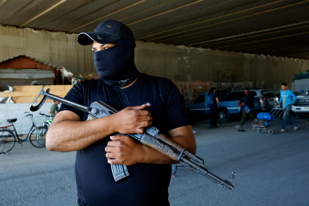 Syrian security forces check vehicles at the entrance of Druze town of Jaramana