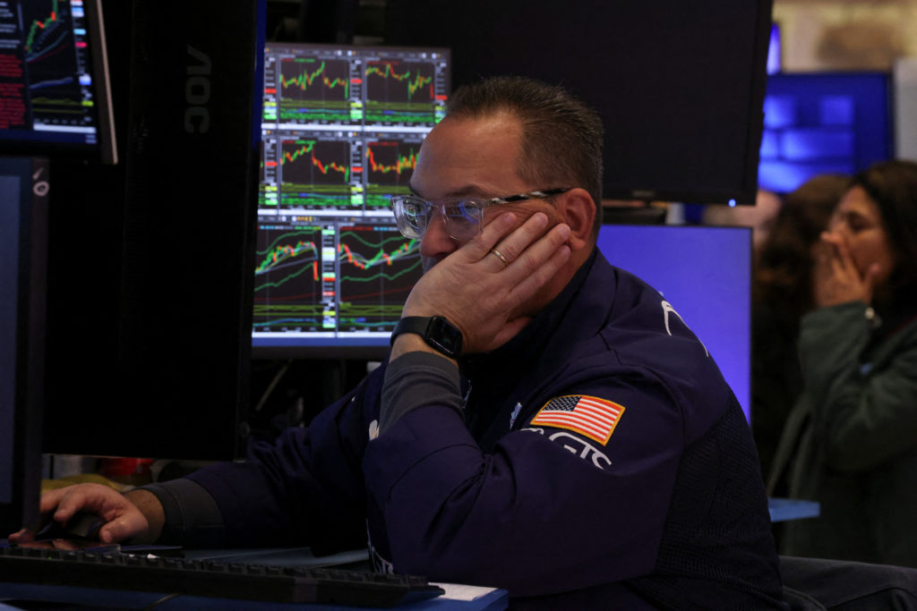 Traders work on the floor at the New York Stock Exchange, in New York City