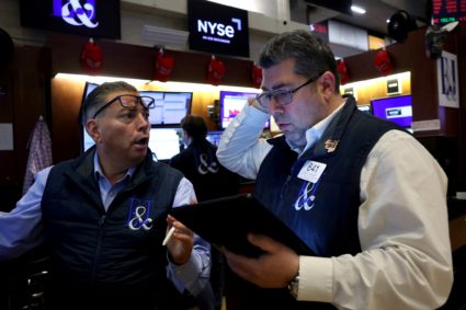 Traders work on the floor of the NYSE in New York