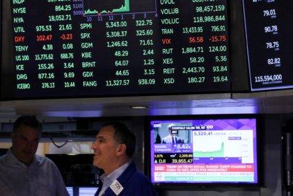 Traders work on the floor at the New York Stock Exchange, in New York City