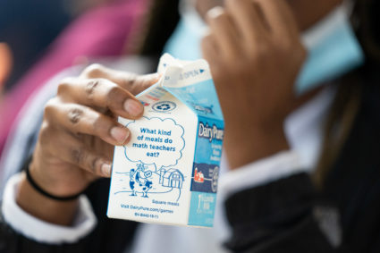 A student holds a milk carton at lunch at Burke County High Sch