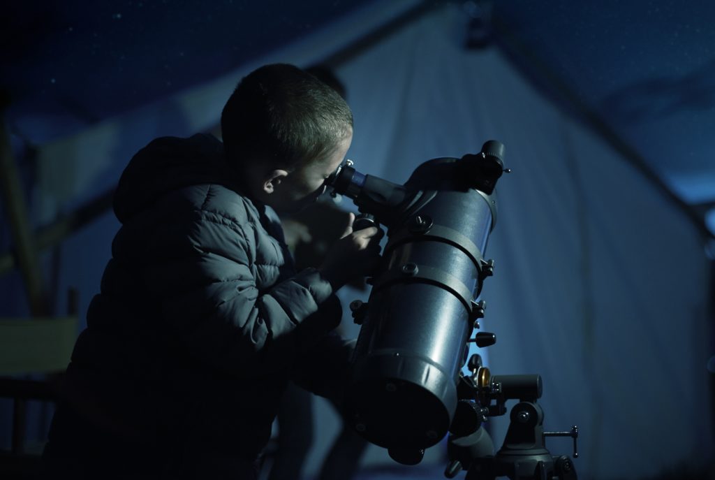 Boy looking through telescope