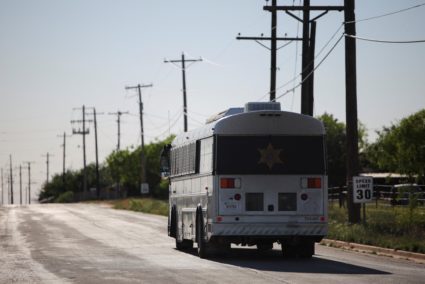 A bus leaves the Bluebonnet Detention Facility after dropping off detainees, in Anson