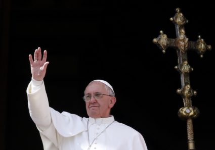 Pope Francis waves during his "Urbi et Orbi" address from a balcony in St. Peter's Square at the Vatican
