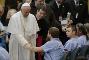 Pope Francis shakes hands with an inmate as he meets with prisoners at Curran-Fromhold Correctional Facility in Philadelphia