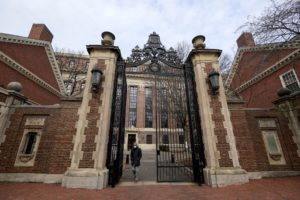 An unidentified person is seen walking through Harvard yard
