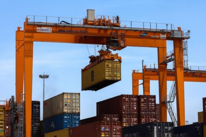 A container is loaded onto a cargo ship while docked at Hai Phong port in Vietnam
