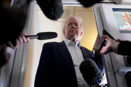 U.S President Donald Trump speaks to members of press onboard Air Force One on a flight to Fiumicino Airport near Rome to ...