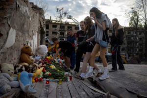 People commemorate victims at site of a Russian missile strike on a residential area in Kyiv