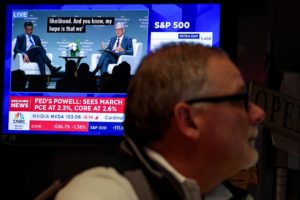 Traders work on the floor of the NYSE in New York