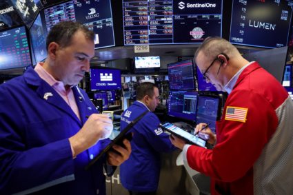 Traders work on the floor of the NYSE in New York