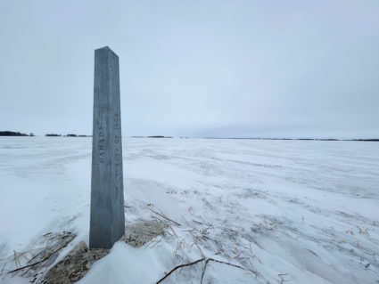 Snow covers the ground around a boundary marker near the Emerson-Pembina crossing in Emerson, Manitoba